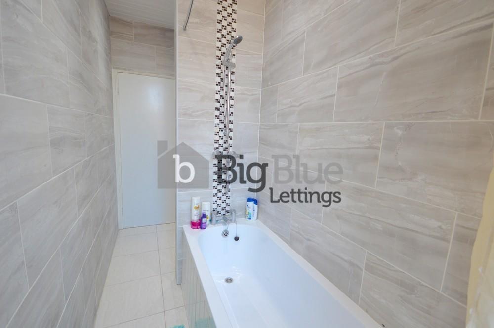 Bright and modern bathroom suite featuring a sl...