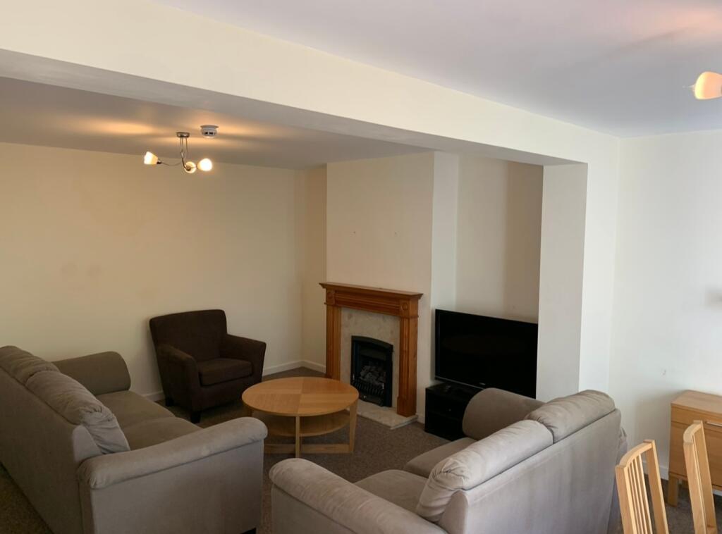 A spacious living room with comfortable seating...