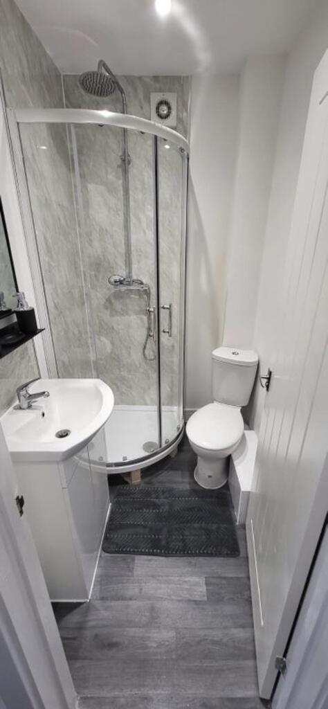 This stylish bathroom features a modern shower ...