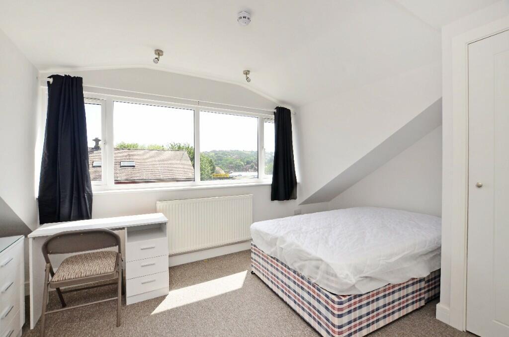 Bright and airy single bedroom featuring a comf...