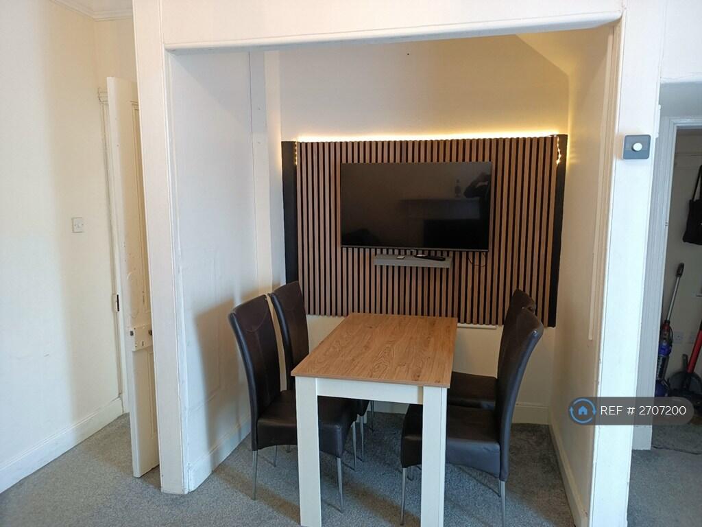 Tv Wall And Dining Area With Large Tv