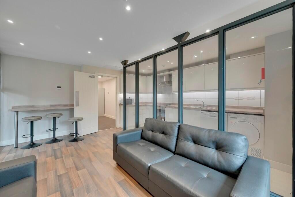 A modern communal lounge featuring comfortable ...