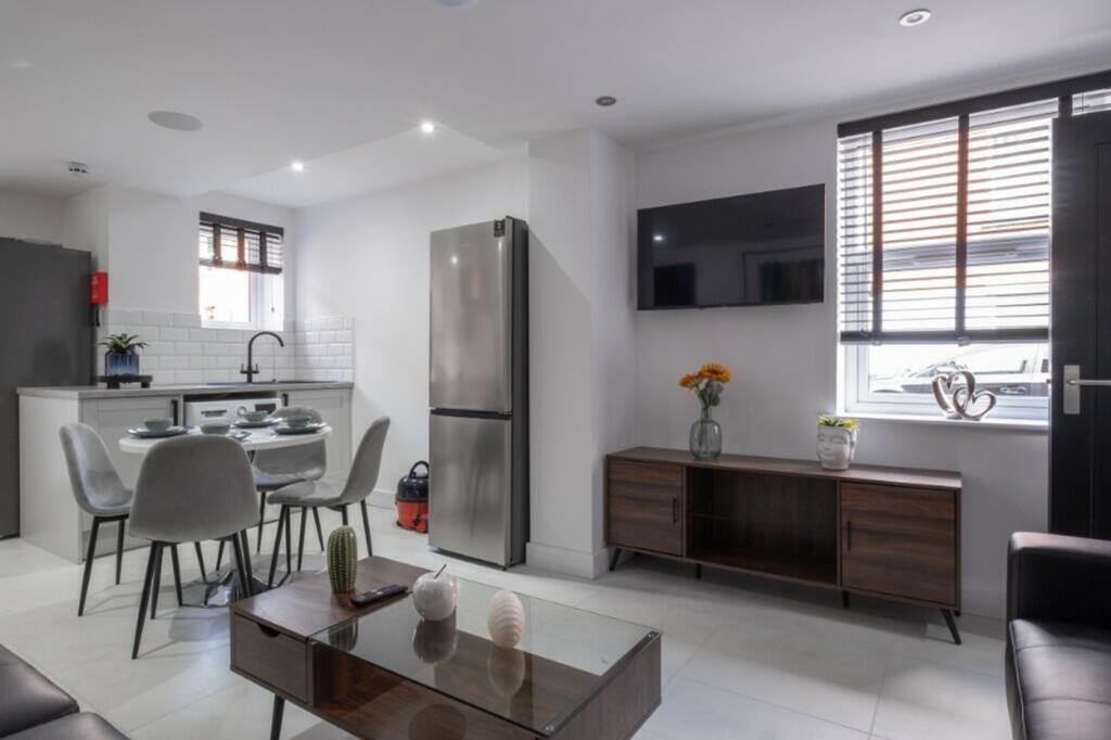 A modern kitchen featuring sleek cabinetry and ...