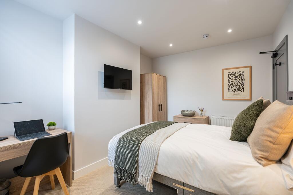 Bright and spacious master bedroom featuring a ...