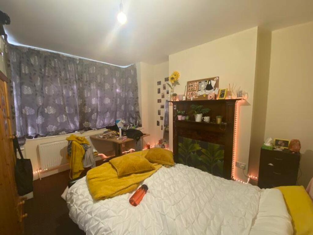 A cozy double bedroom featuring bright decor an...