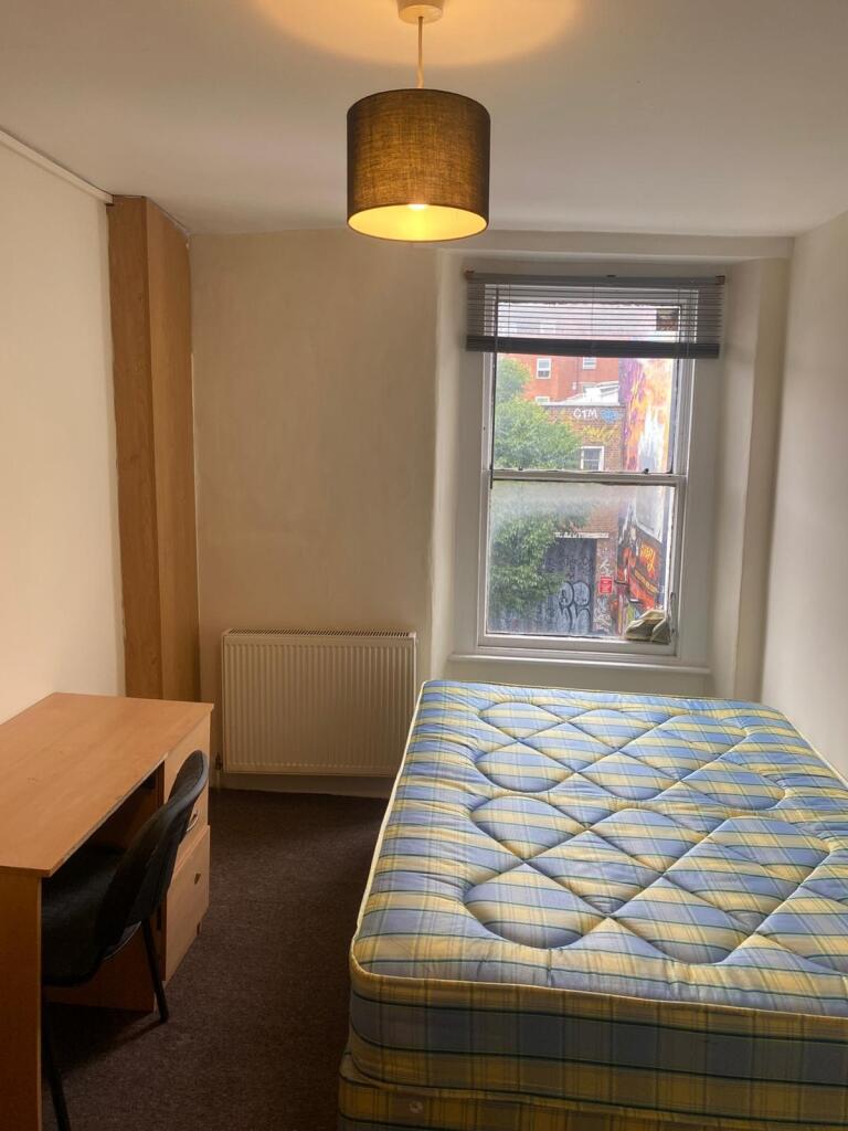 A neat double bedroom featuring a comfortable m...