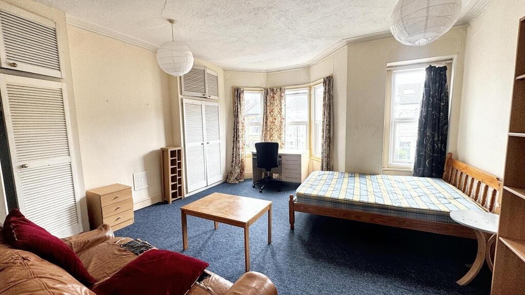 Bright and inviting living room with large wind...