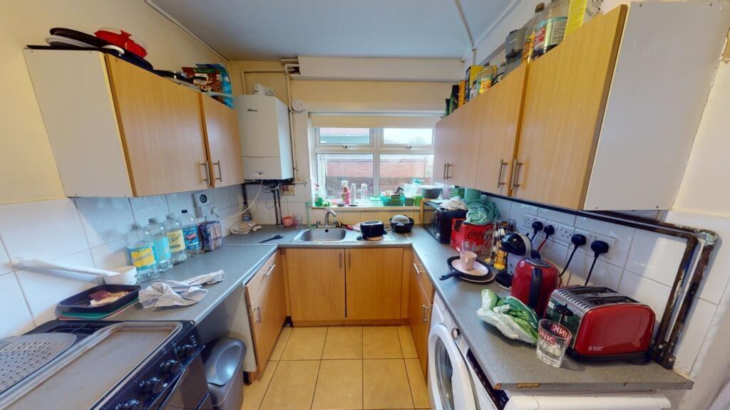 Bright and functional kitchen with ample natura...