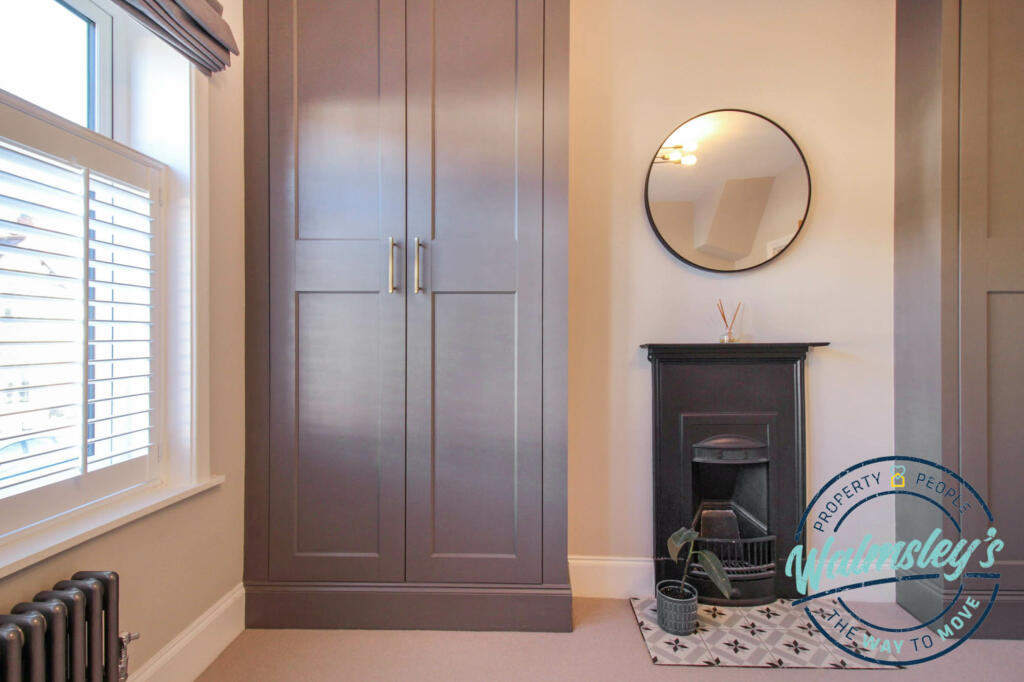 Main bedroom fitted wardrobes &amp; fire place