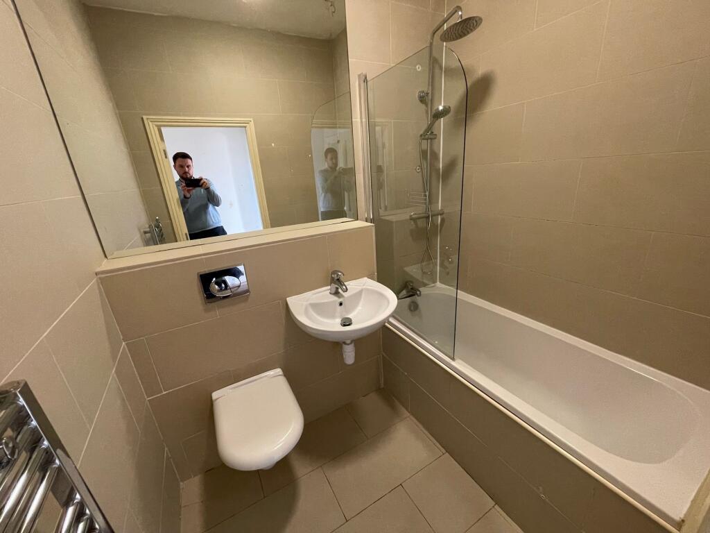 A modern bathroom suite featuring a full-sized ...