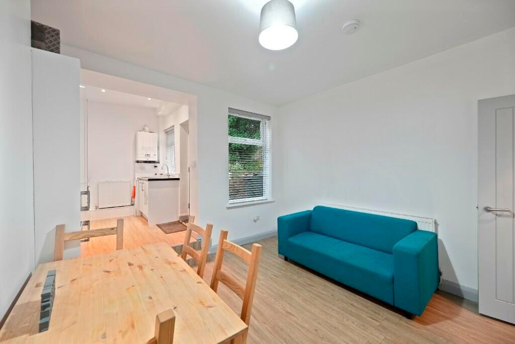 A bright and tidy living room featuring a moder...