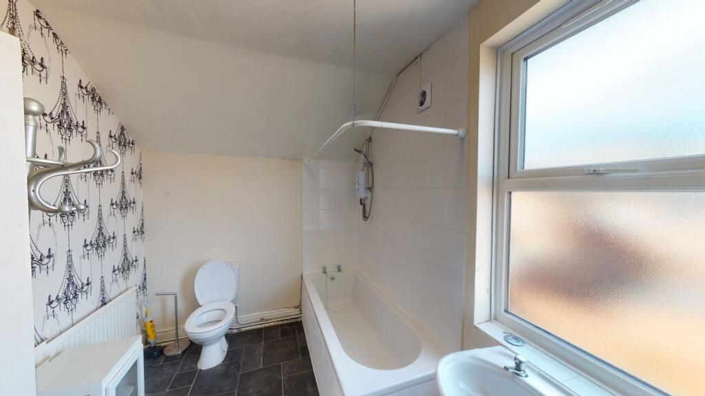 Bright and well-maintained bathroom featuring a...