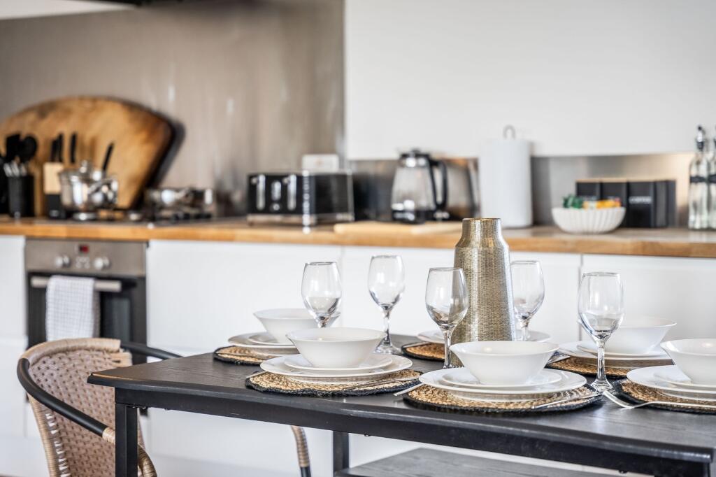 This stylish kitchen features a modern design w...