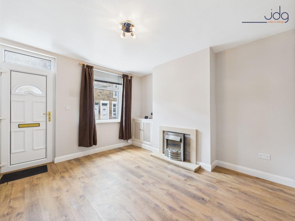 Lounge with wood-effect flooring and electric fire