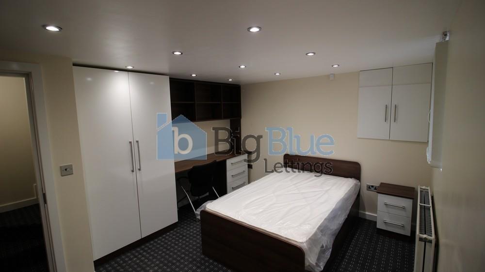 A modern, well-kept double bedroom featuring a ...