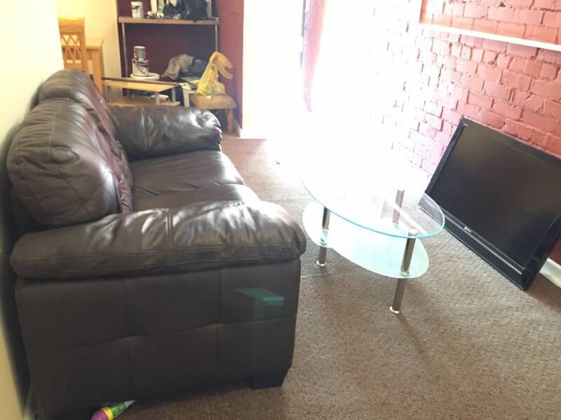 A cozy living room featuring a comfortable leat...