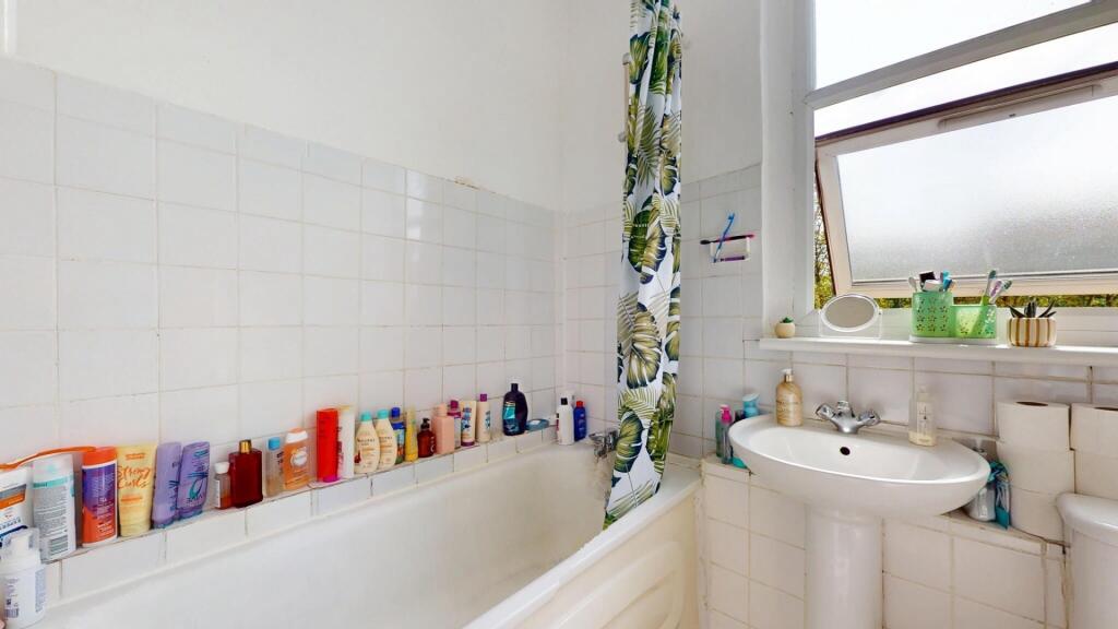 A bright and functional bathroom featuring a ba...