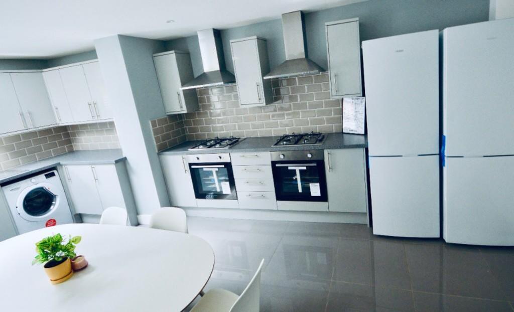 A spacious and modern kitchen featuring ample s...