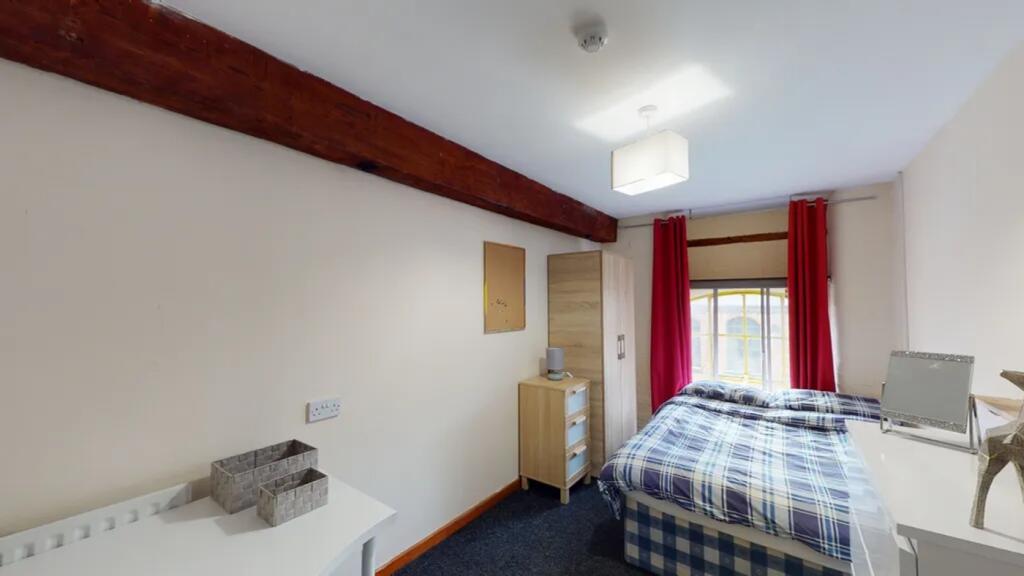 A bright and inviting double bedroom with moder...