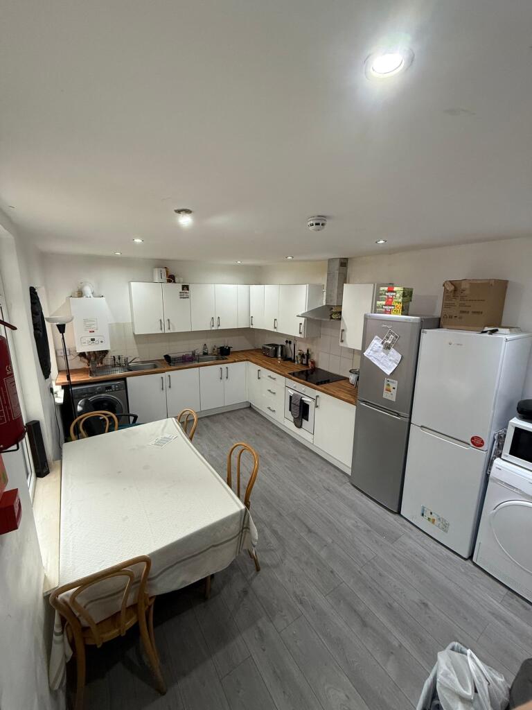A well-equipped kitchen featuring ample cabinet...