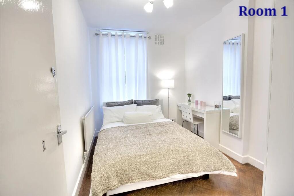 A bright and clean double bedroom featuring a c...
