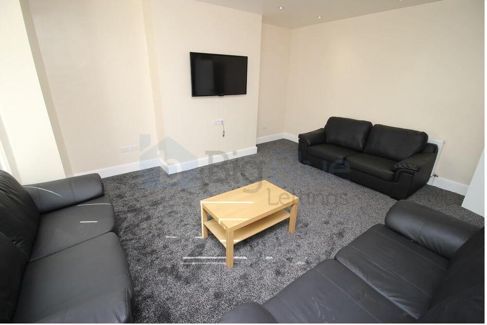 A spacious communal lounge featuring three blac...