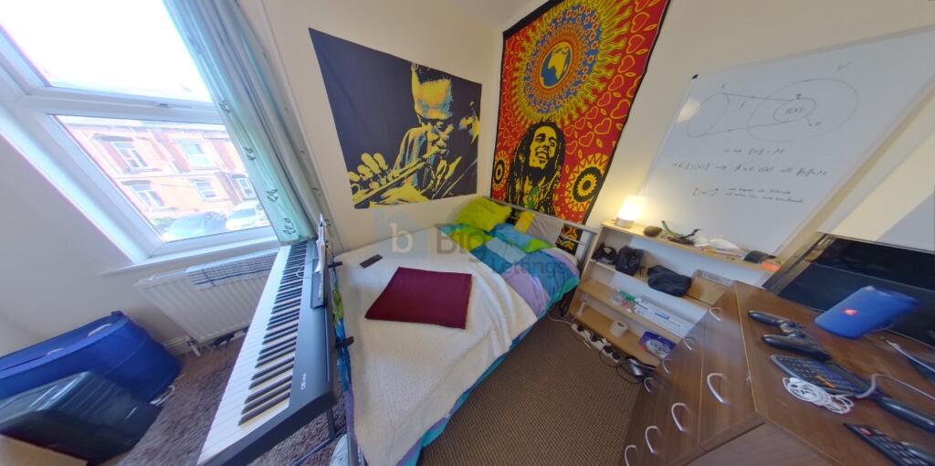 A cozy and colorful single bedroom featuring a ...