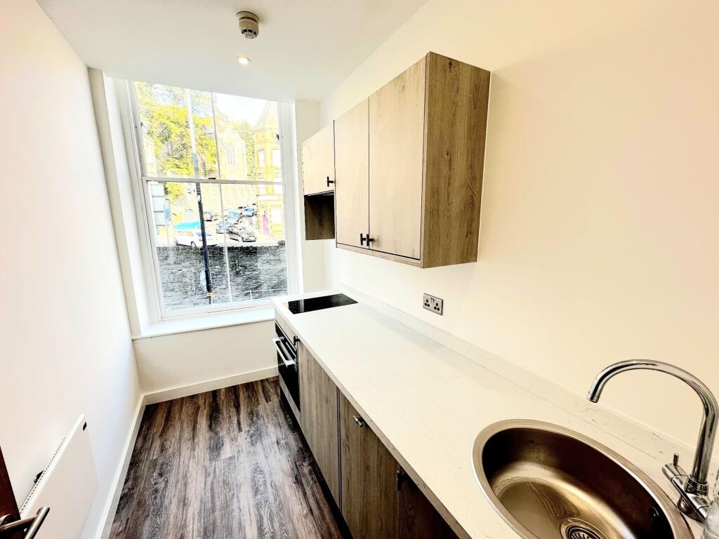 Modern kitchen with a large window providing ab...