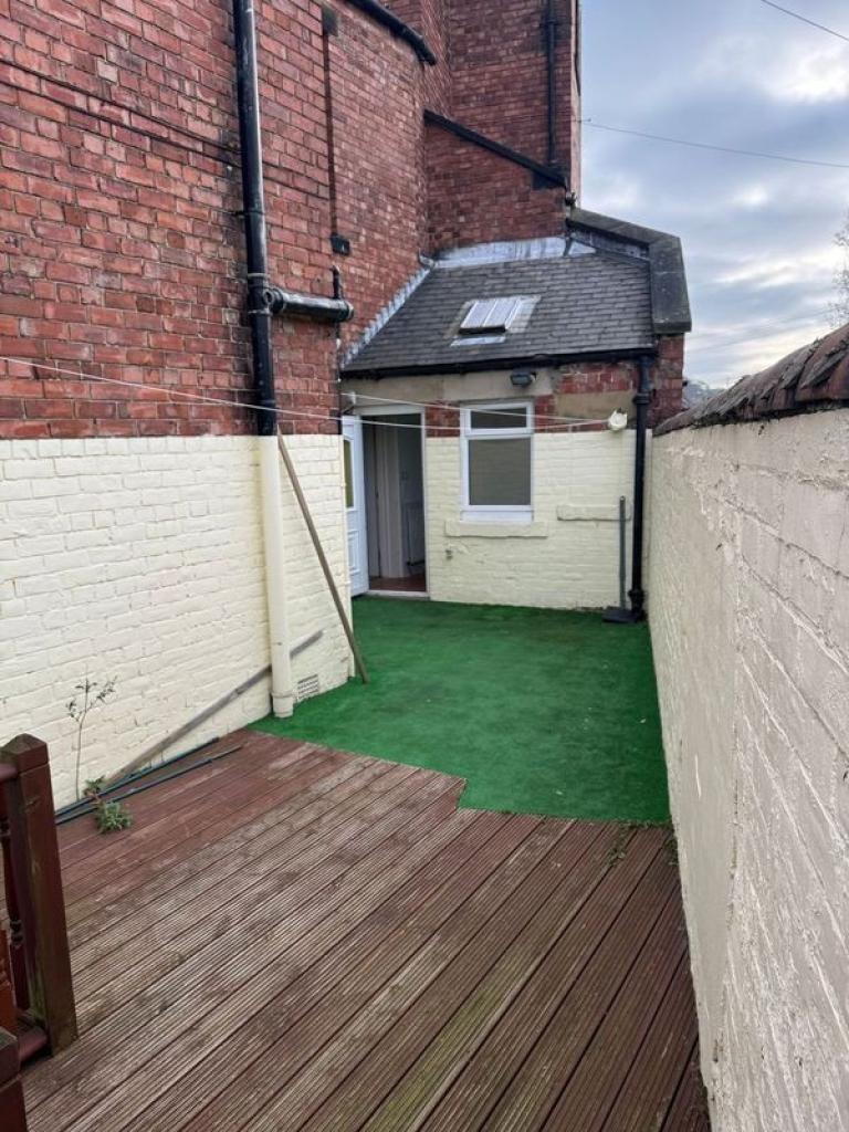 A charming outdoor garden space featuring a mix...