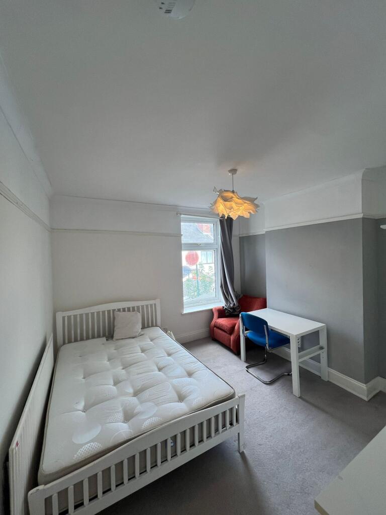 A cozy double bedroom featuring a comfortable w...