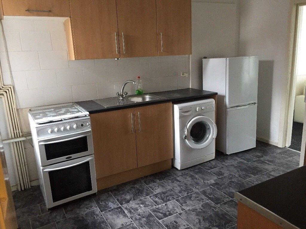 Bright, practical kitchen with fitted cabinets,...