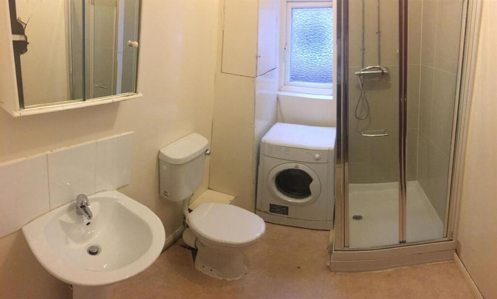 Bright, practical bathroom with a sink and mirr...