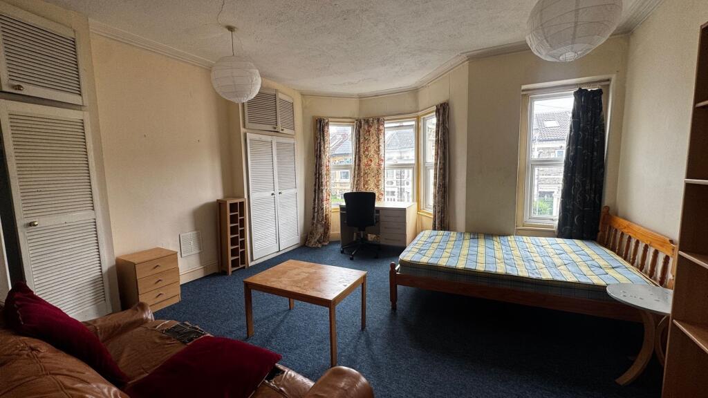 Bright and welcoming bedroom featuring a wooden...