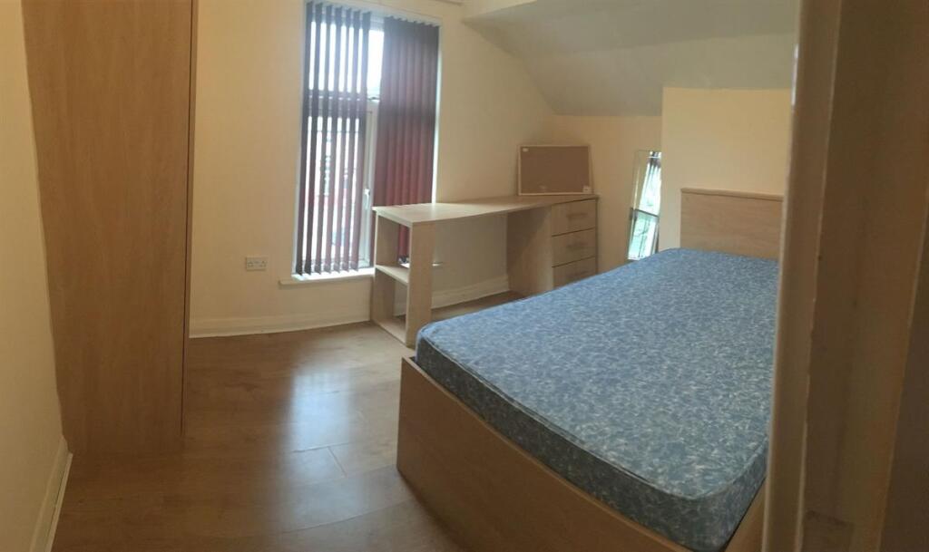Bright furnished bedroom with a double bed, bui...