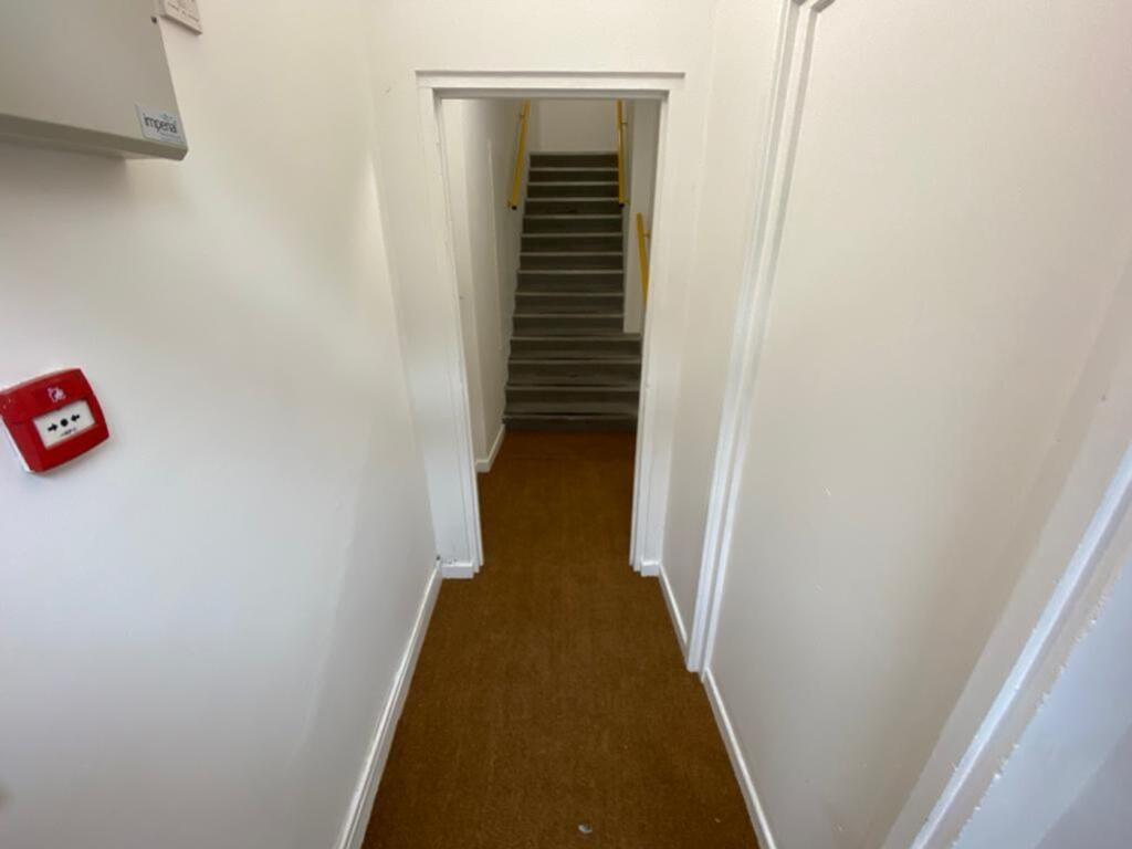 A well-maintained staircase leading to upper le...