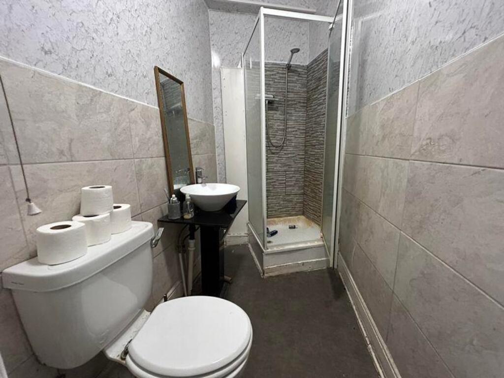 A tidy and functional bathroom featuring a show...