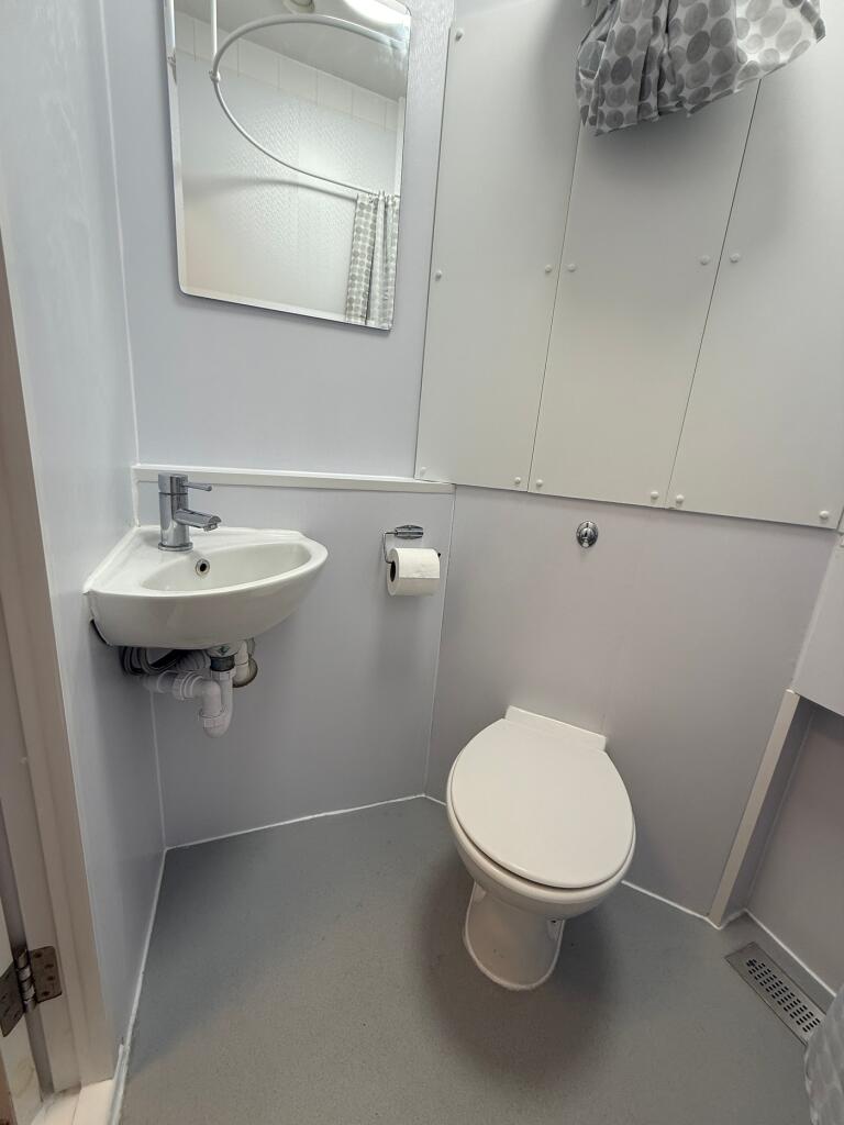 A modern bathroom featuring a clean design with...