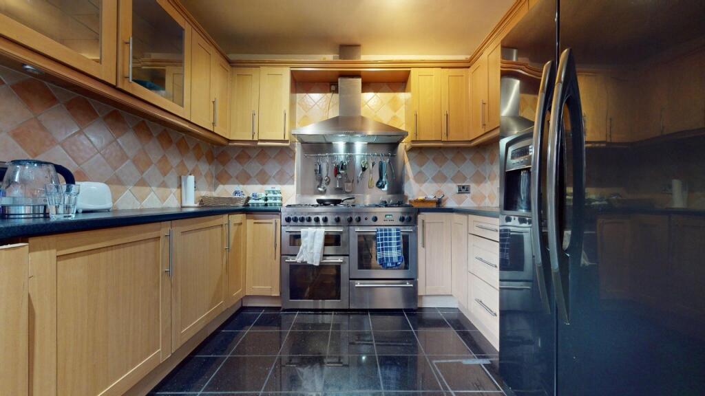 Modern kitchen with wooden cabinetry, stainless...