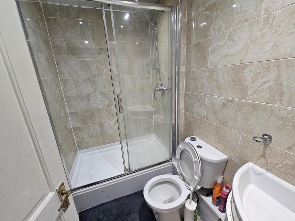 A spacious and modern bathroom featuring a larg...