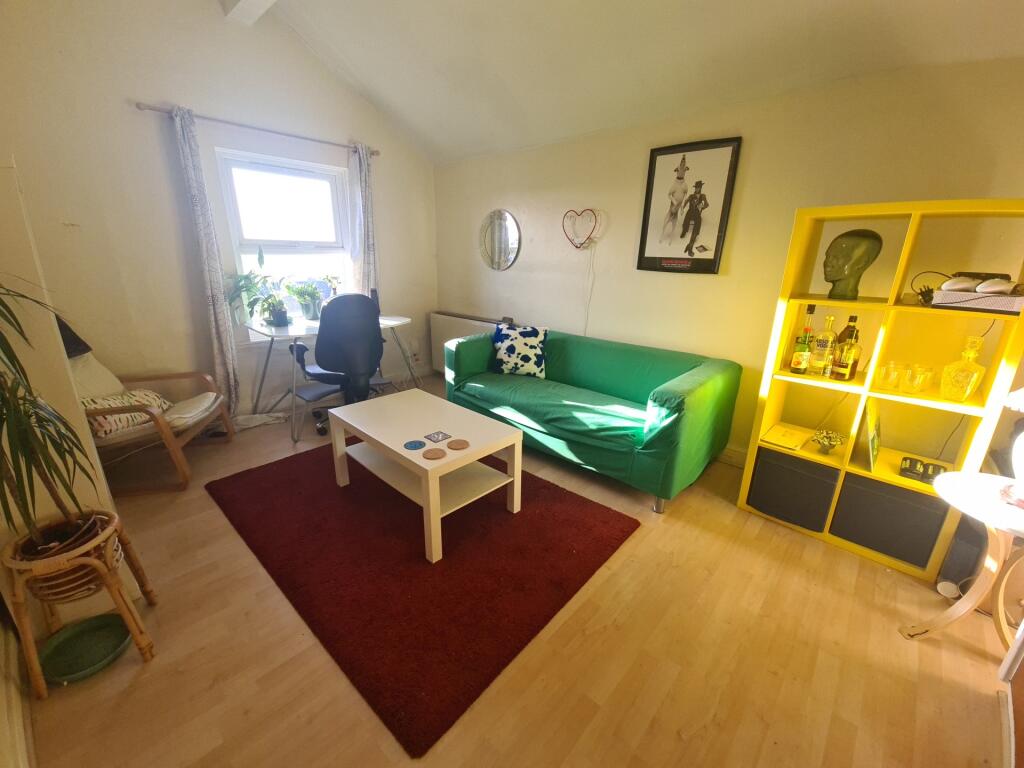 A bright and welcoming living room featuring a ...