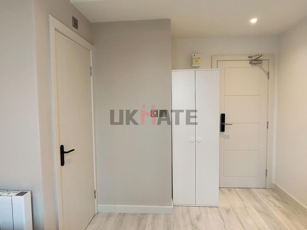 Bright and well-maintained hallway with white d...