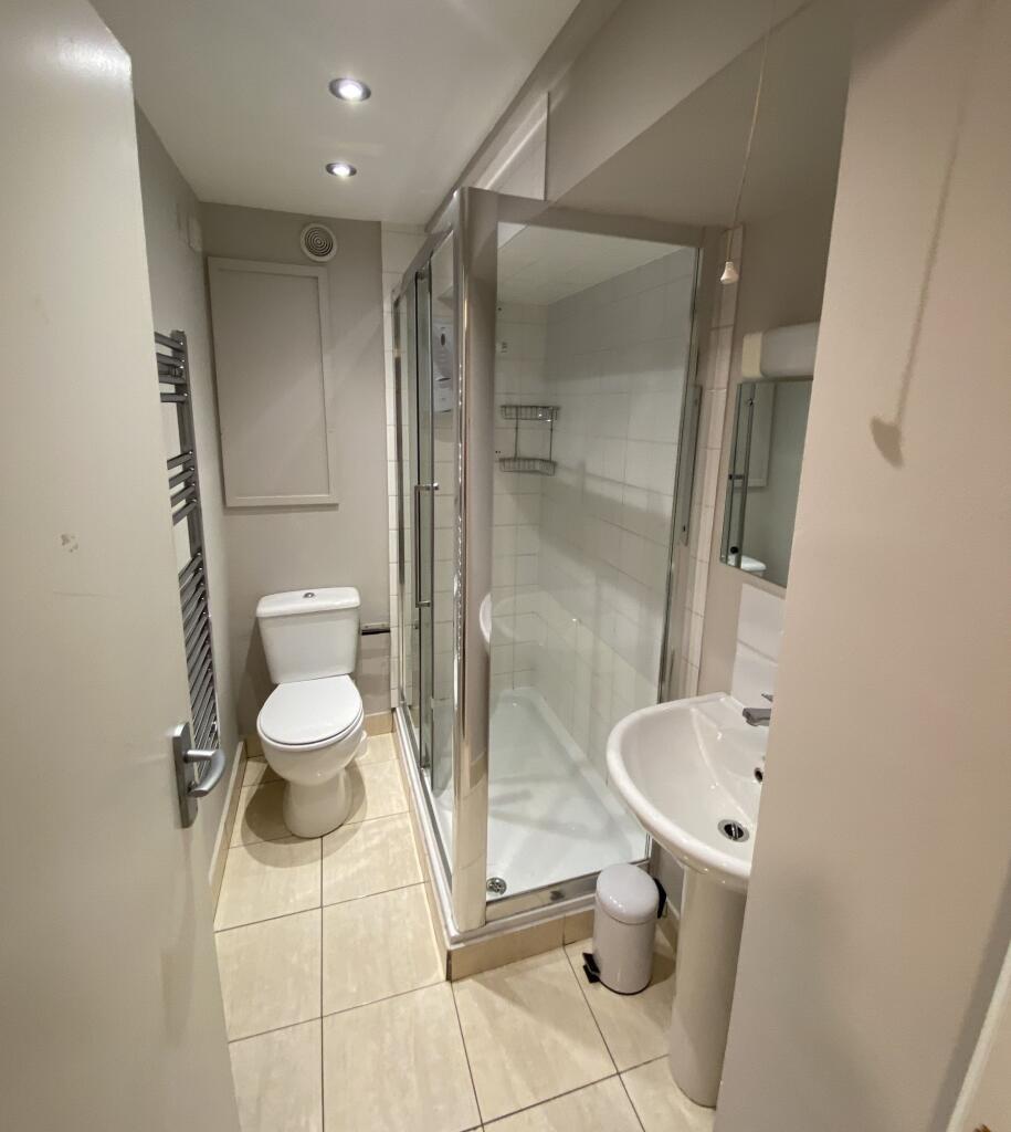 Bright and modern bathroom featuring a fully en...