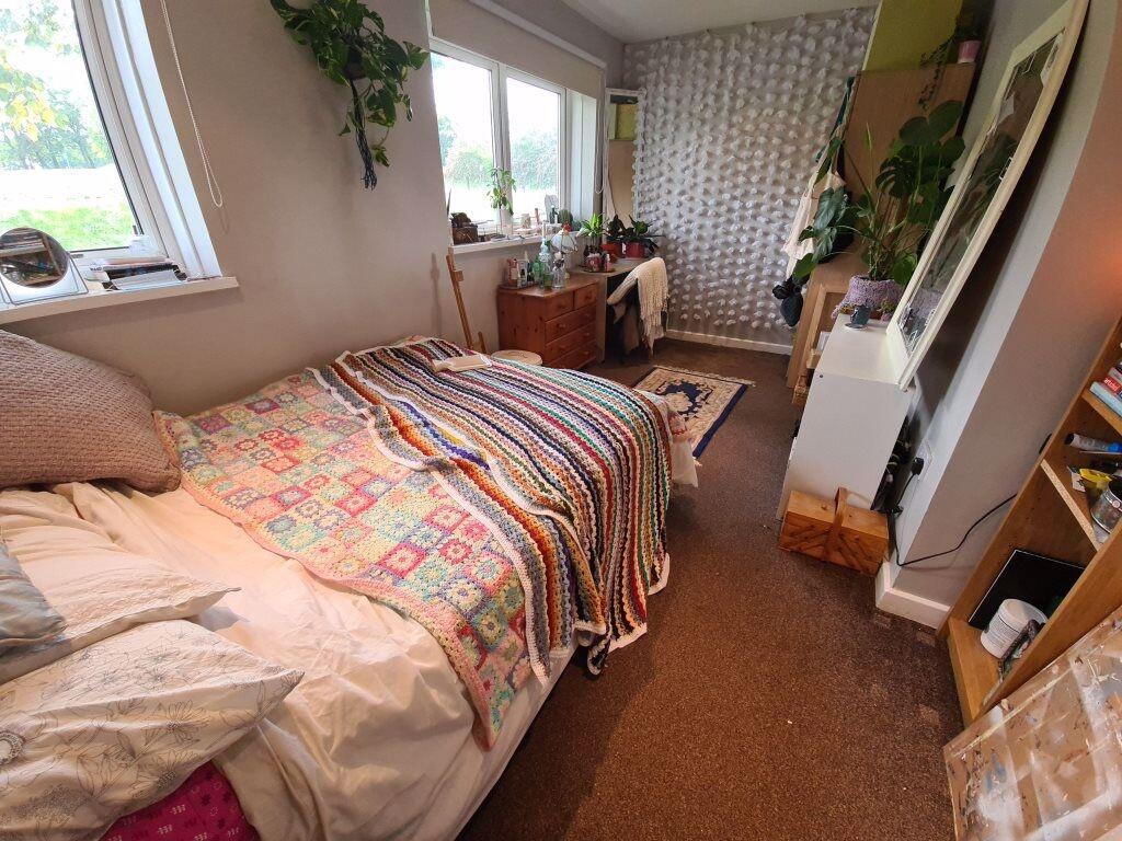 A cozy single bedroom featuring a comfortable b...