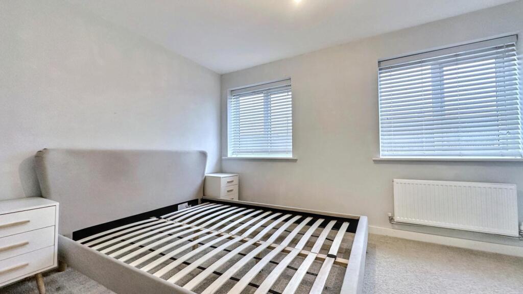A bright and spacious double bedroom featuring ...