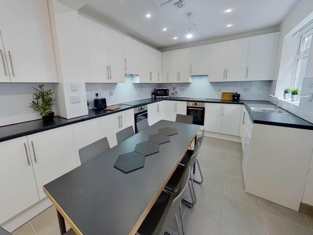 Modern and spacious kitchen with ample storage,...