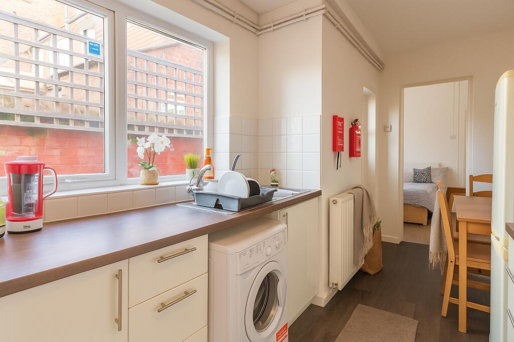 Bright and tidy kitchen featuring ample counter...