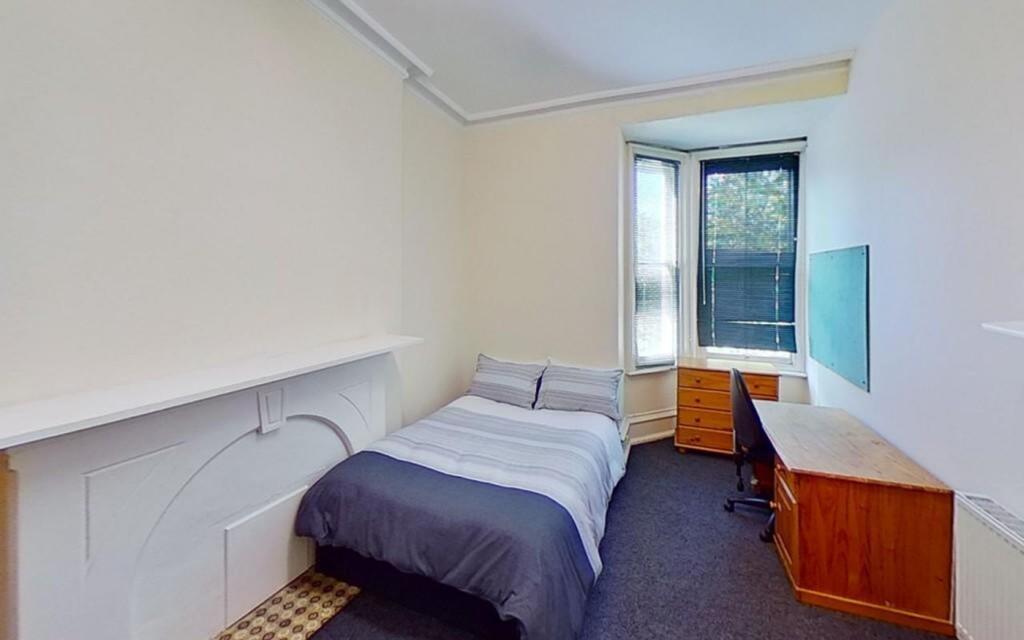 This inviting double bedroom features a cozy la...