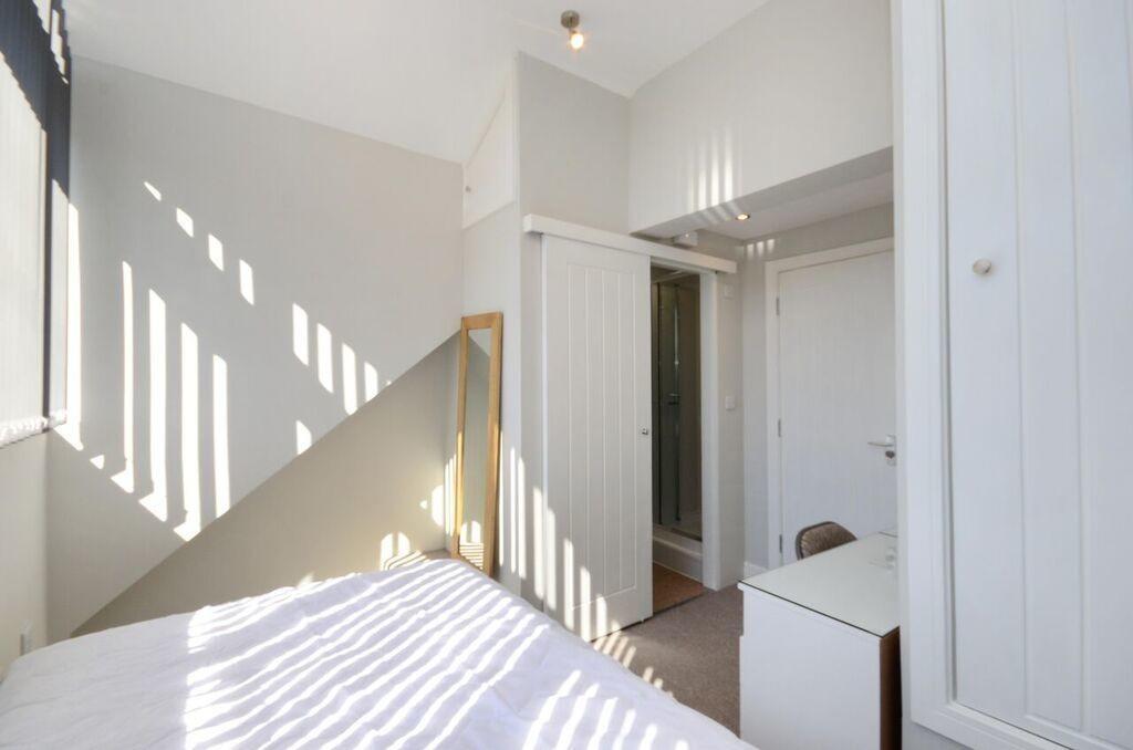 Bright and airy master bedroom featuring abunda...