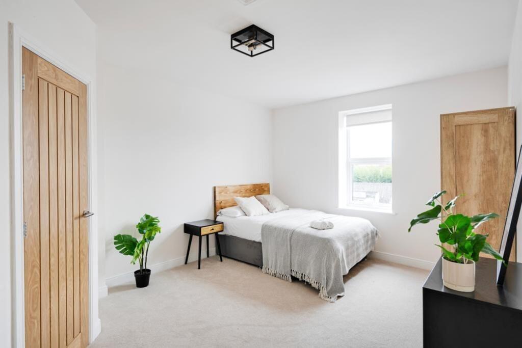 A clean and bright double bedroom with a modern...