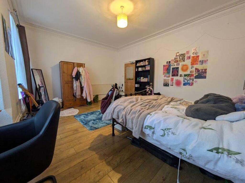 A spacious and inviting double bedroom, featuri...